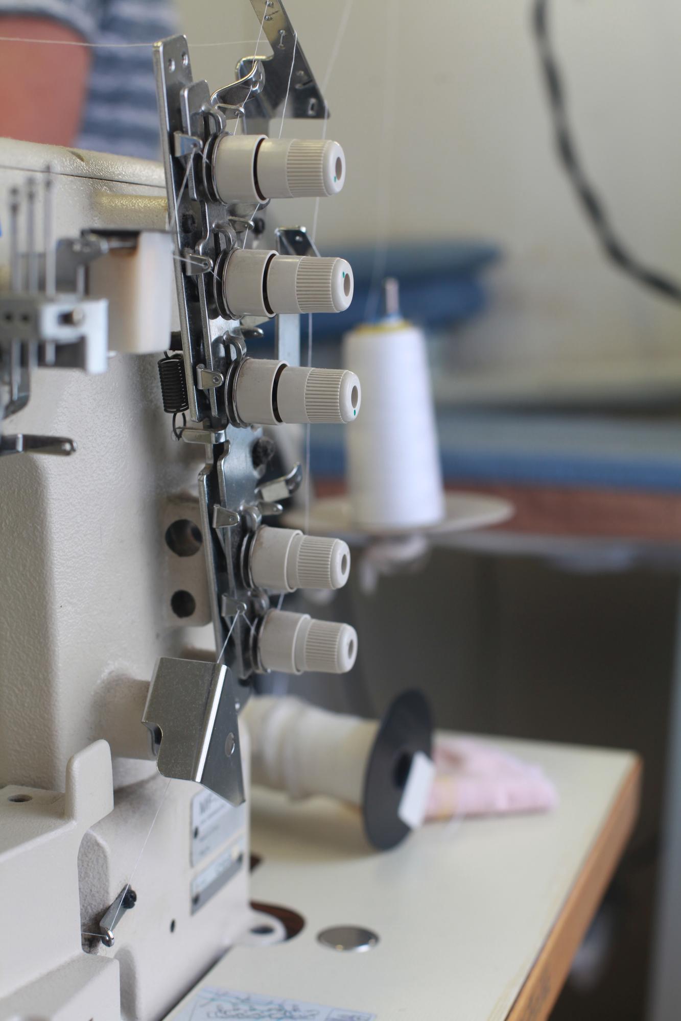 Studio corner with embroidery machine and threads