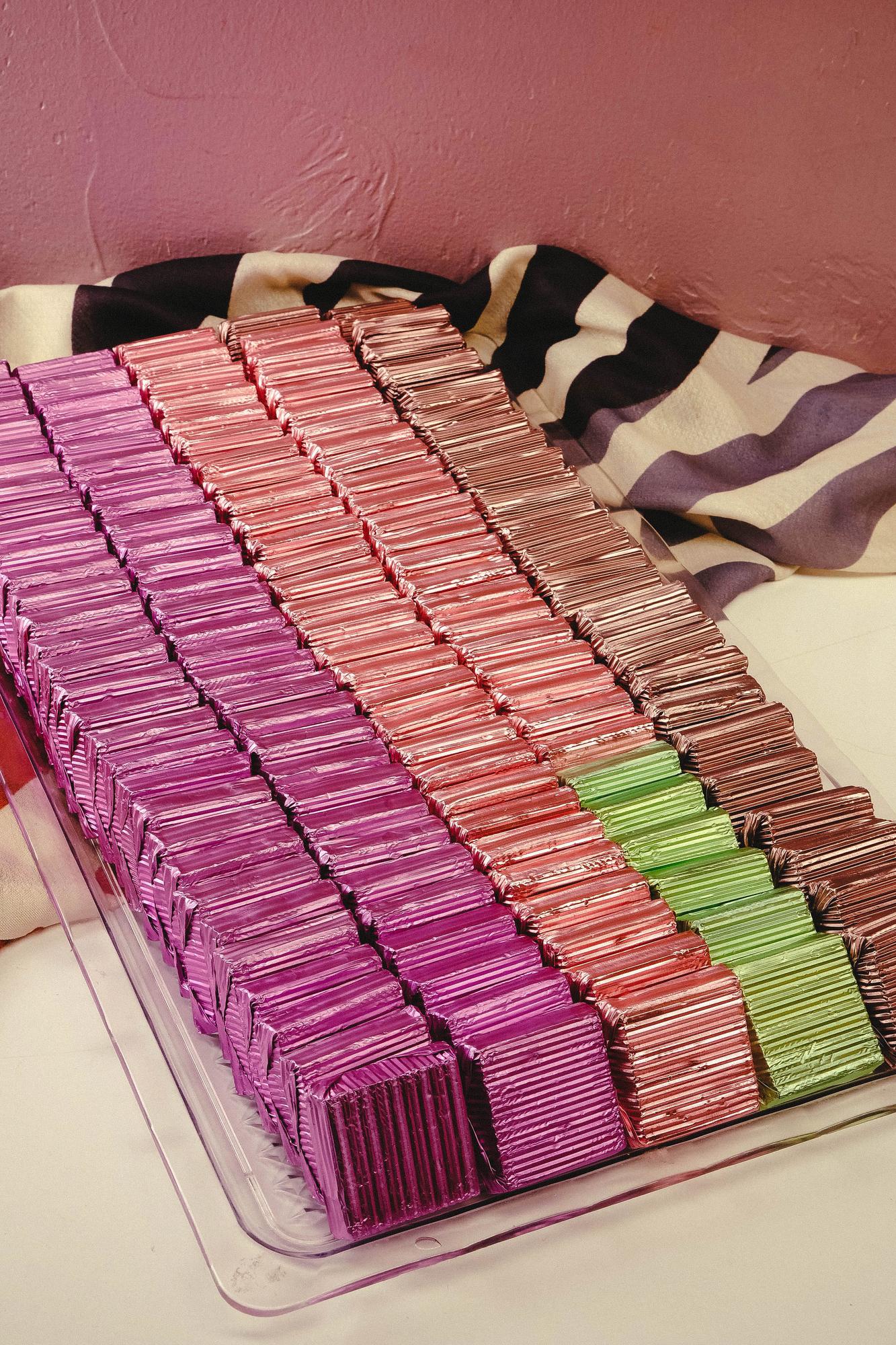 Stack of embroidered swatches in neutral tones